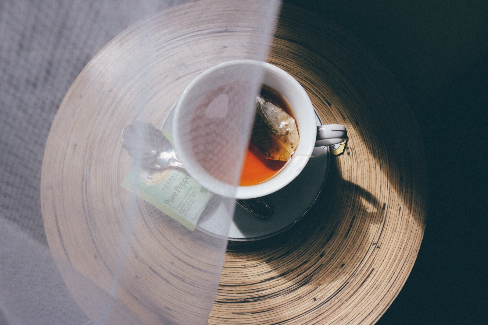 a cup of tea partly obscured by net fabric